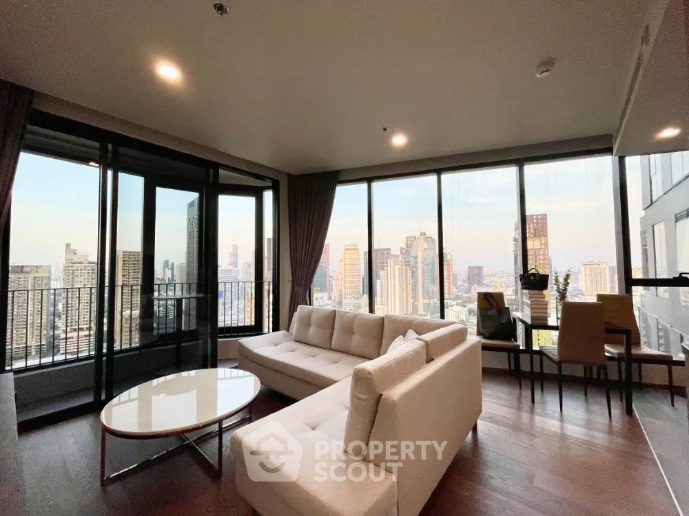 Luxurious high-rise living room with panoramic city views and modern furnishings.