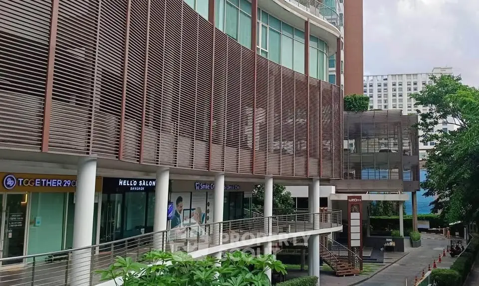 Modern commercial building with unique architectural design and lush greenery