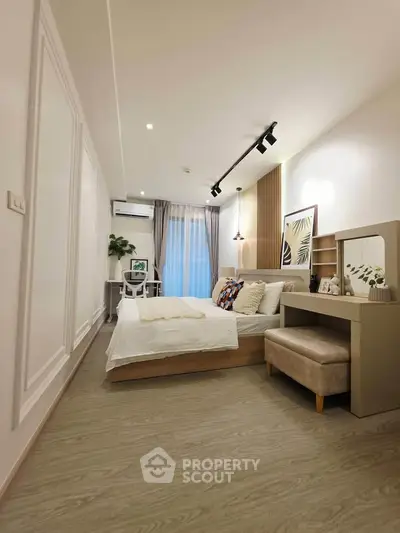 Modern bedroom with stylish decor and cozy ambiance, featuring a comfortable bed and elegant furnishings.
