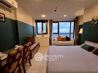 Modern bedroom with city view, cozy seating area, and stylish decor