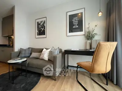 Modern living room with stylish decor, cozy sofa, and workspace in a contemporary apartment.