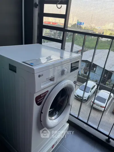 Modern washing machine on balcony with city view, perfect for urban living convenience.