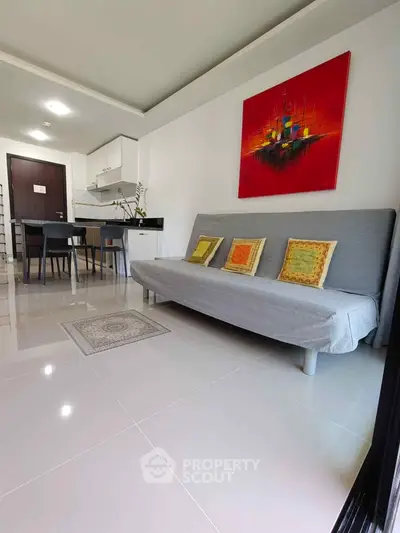Modern living room with sleek furniture and vibrant artwork in a stylish apartment.