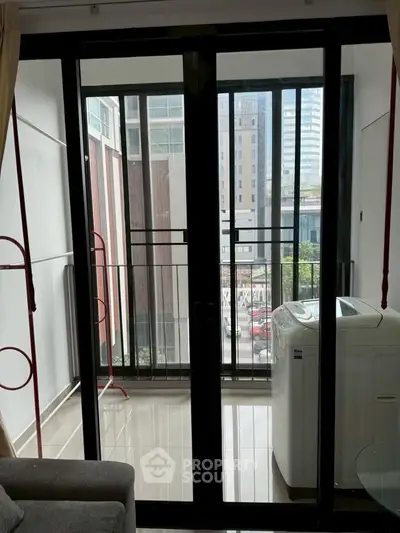Modern apartment balcony with washing machine and city view