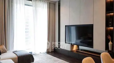 Luxurious modern living room with large TV and elegant decor