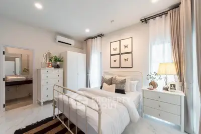 Charming bedroom with elegant decor, featuring a cozy bed, stylish furniture, and soft lighting for a serene ambiance.