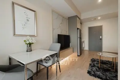 Modern living room with stylish decor and open layout, featuring a sleek dining area and contemporary furniture.