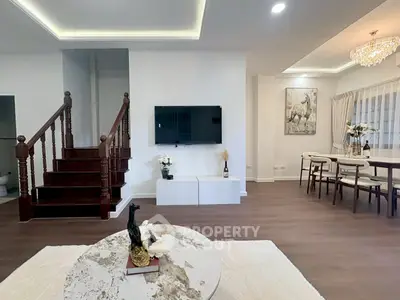 Elegant living room with modern decor, wooden staircase, and dining area, perfect for stylish urban living.