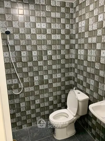 Modern bathroom with stylish tile design and shower setup
