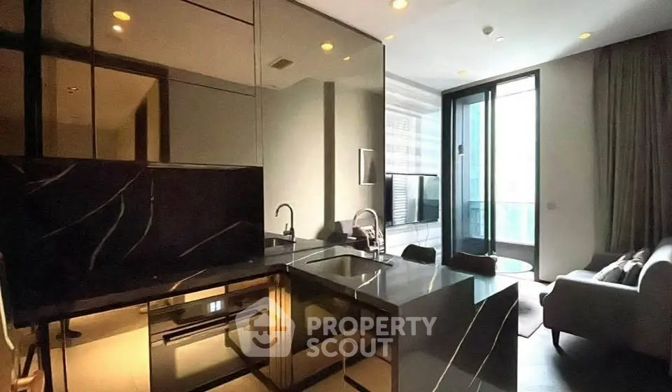Modern kitchen with sleek design and open layout leading to a bright living area.