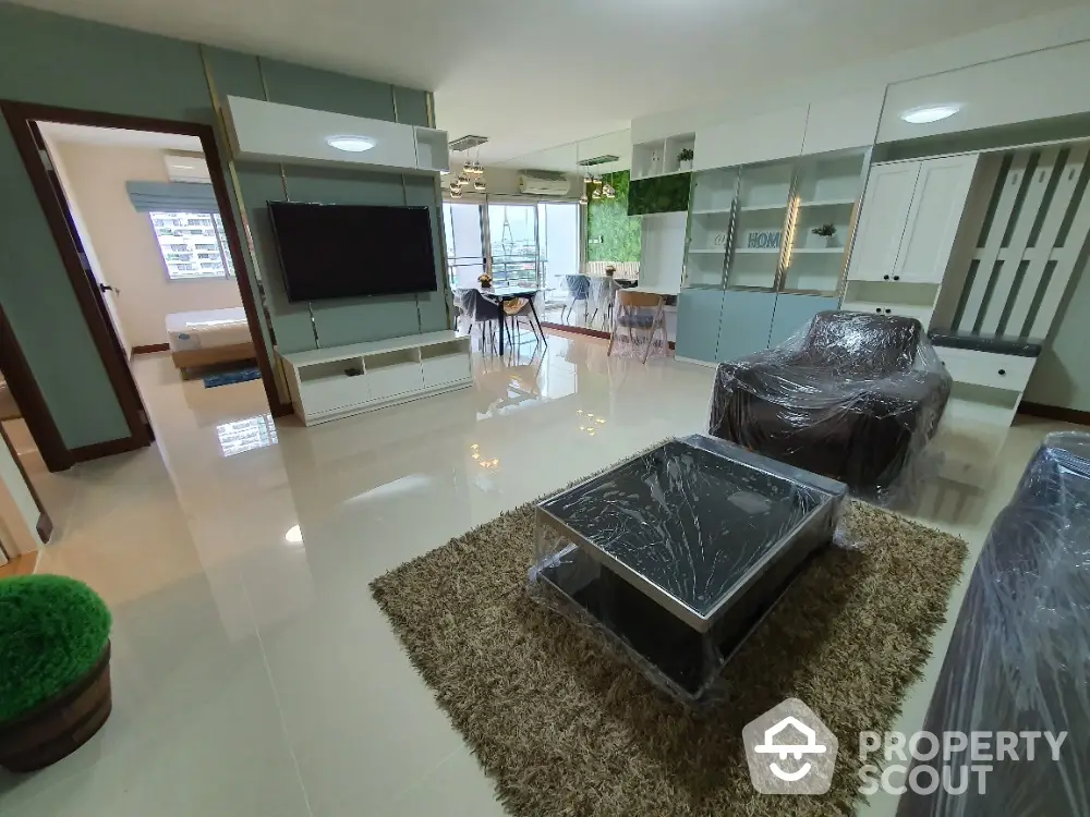 Spacious modern living room with open layout and stylish furniture, perfect for family gatherings.