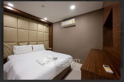 Modern bedroom with cozy bed and air conditioning in stylish apartment