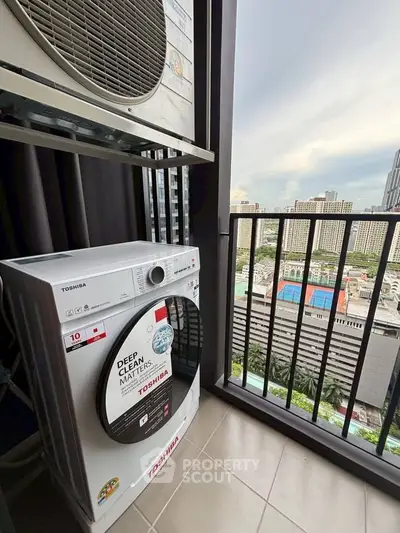 High-rise apartment balcony with washing machine and city view
