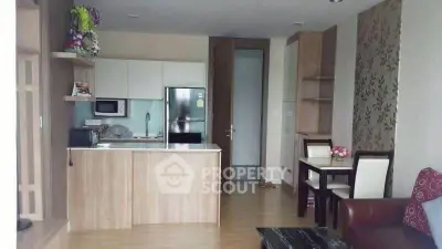 Modern open-layout kitchen and dining area with stylish decor and wooden flooring.