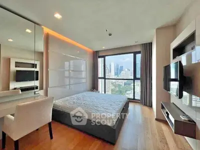 Modern bedroom with city view, featuring sleek design and large window for natural light.
