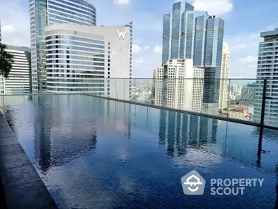 Luxurious rooftop pool with stunning city skyline view in modern high-rise building.