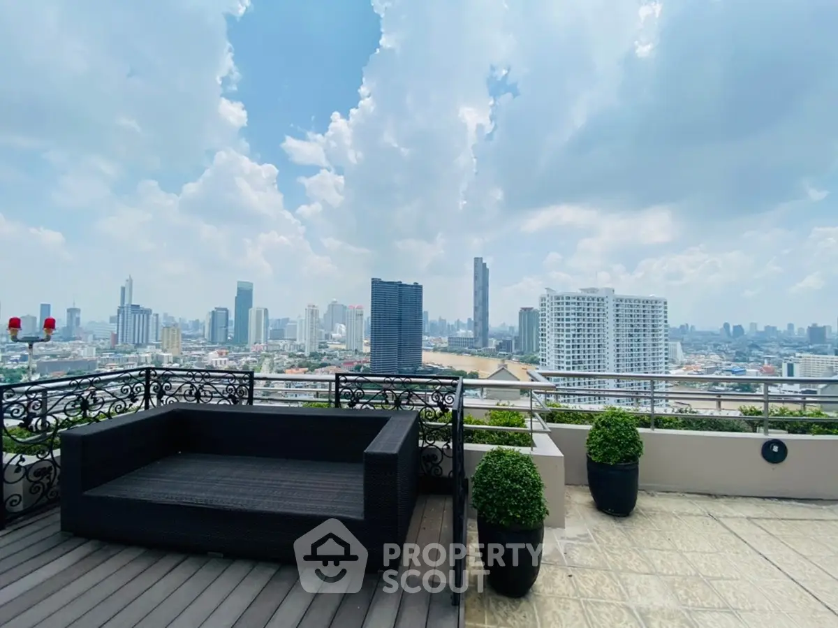 Stunning rooftop terrace with panoramic city skyline views and elegant outdoor seating.