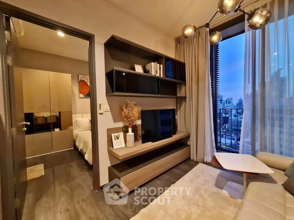 Modern living room with city view, stylish shelving, and cozy decor in urban apartment.