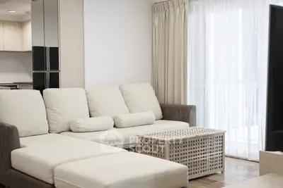 Modern living room with cozy white sofa and stylish coffee table in bright apartment.