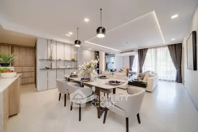 Luxurious open-plan living and dining area with modern decor and elegant lighting.