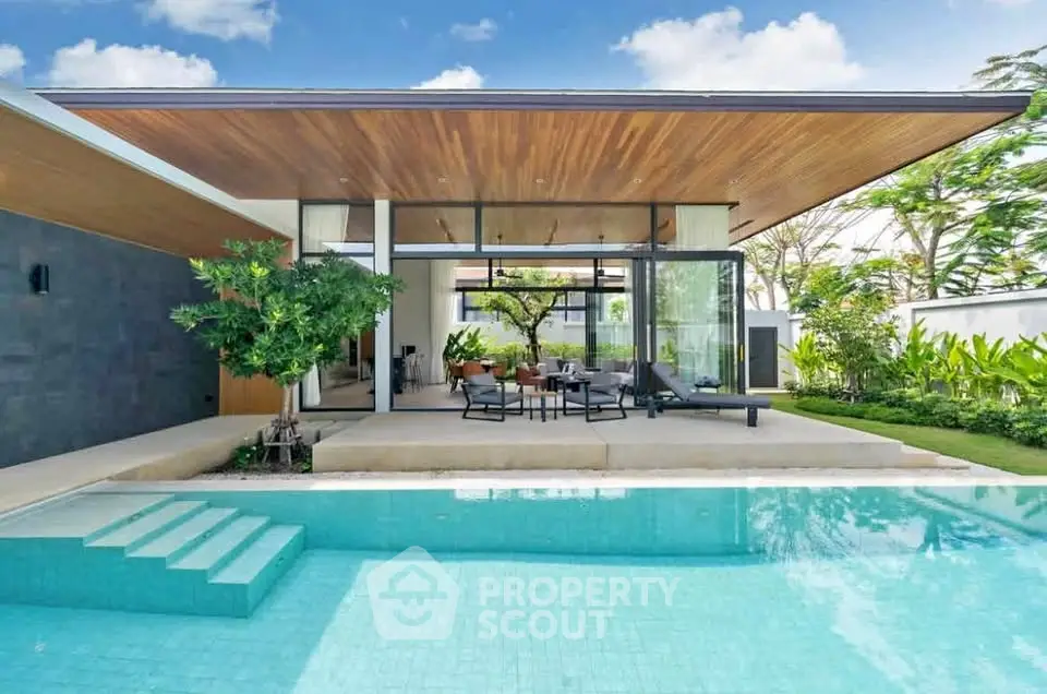 Luxurious modern villa with stunning pool and lush garden, perfect for serene living.