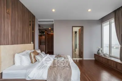 Luxurious bedroom with stunning river view and elegant wooden accents