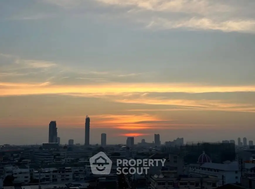 Stunning city skyline view at sunset with high-rise buildings and vibrant sky.
