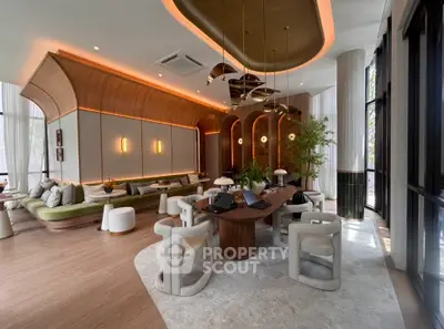 Luxurious modern living room with elegant decor and stylish furniture, featuring ambient lighting and large windows.