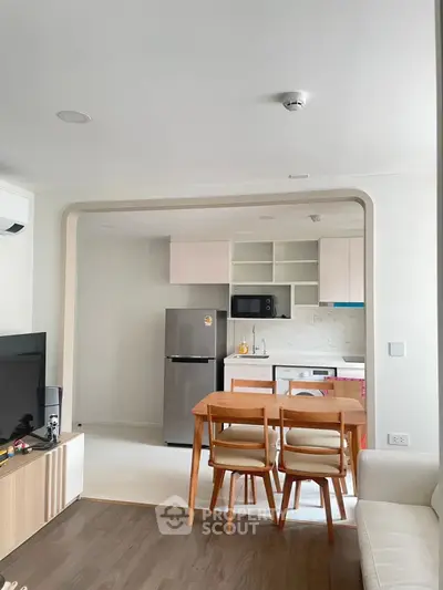 Modern open-layout kitchen with dining area and sleek appliances