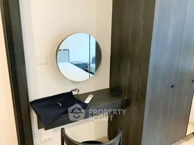 Modern bedroom with sleek vanity mirror and dark wood wardrobe