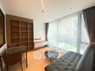 Modern living room with large windows and stylish furniture in a bright apartment.