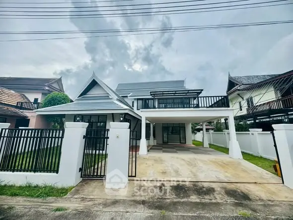 Charming modern house with spacious driveway and stylish roof design in a serene neighborhood.