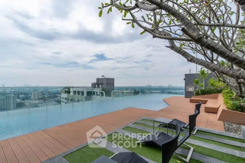 Luxurious rooftop pool with stunning city view and modern lounge area.