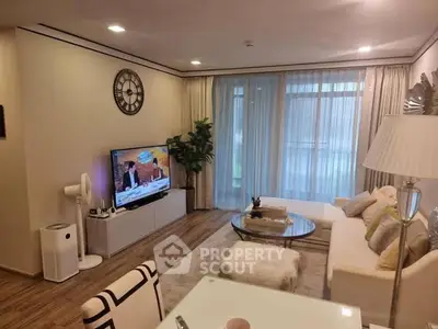 Elegant living room with modern decor and large window for natural light