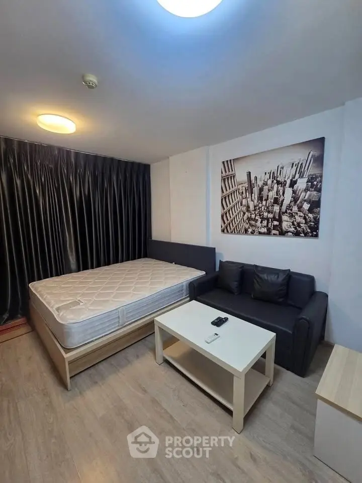 Modern studio apartment with cozy living area and stylish decor, perfect for urban living.