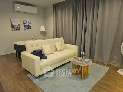 Modern living room with stylish sofa, air conditioning, and elegant decor.