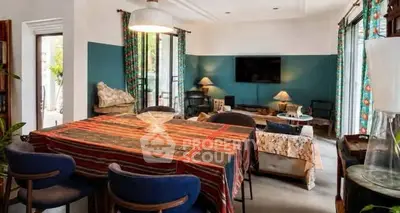 Charming living room with eclectic decor and vibrant colors, perfect for cozy gatherings.