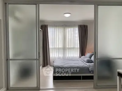 Modern bedroom with frosted glass sliding doors and elegant curtains