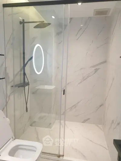 Modern bathroom with sleek shower and elegant marble tiles