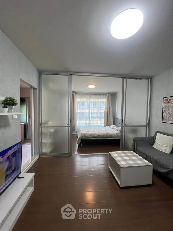 Modern studio apartment with sliding glass doors and cozy living area