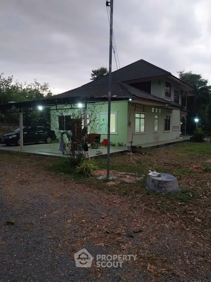 Charming two-story house with spacious yard and carport, ideal for family living.