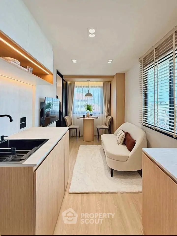 Modern open-plan kitchen and living area with sleek design and natural light.