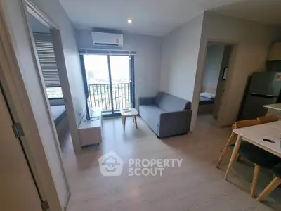 Modern apartment living room with balcony view and sleek furnishings