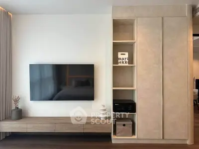 Modern living room with sleek TV setup and stylish storage solutions.