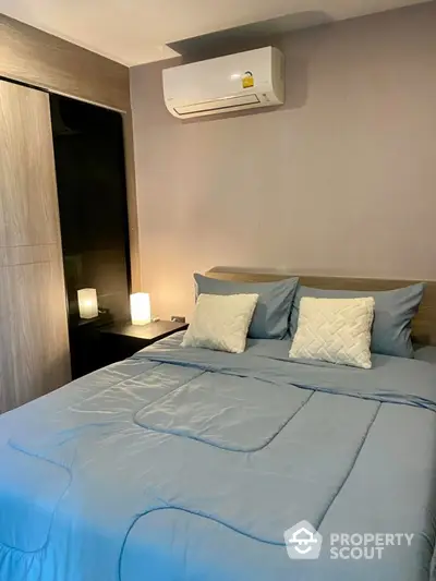 Cozy bedroom with modern air conditioning and stylish bedding