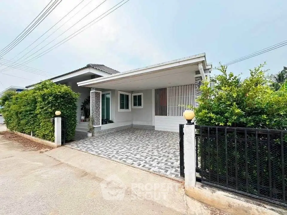 Charming single-story home with modern facade and spacious driveway