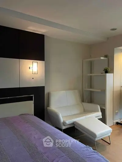Modern bedroom with stylish decor and cozy seating area