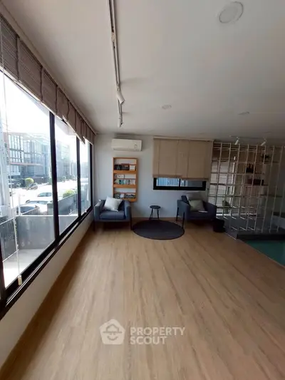 Spacious modern living room with large windows and stylish seating area