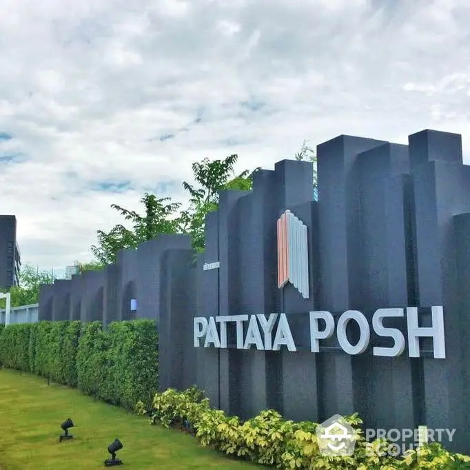 Luxurious Pattaya Posh condominium entrance with modern design and lush greenery