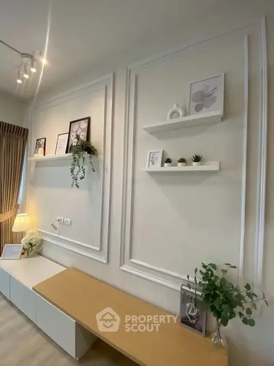 Elegant living room with modern decor, featuring wall shelves and stylish lighting, perfect for contemporary living.